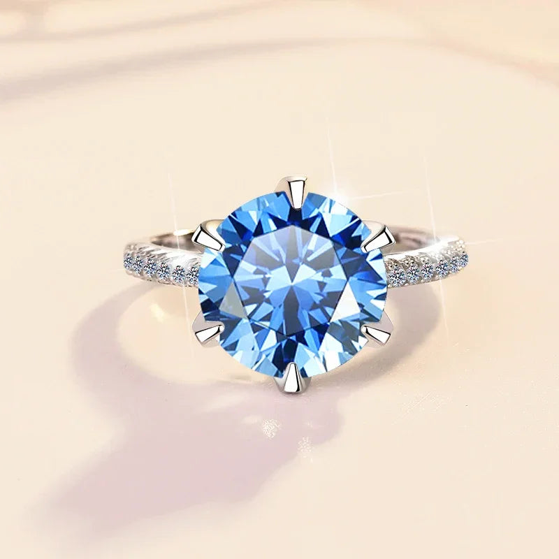 Ring with a blue gemstone on a beige background