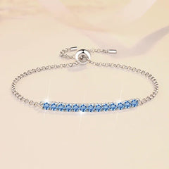 Silver bracelet with blue gemstones on a beige background
