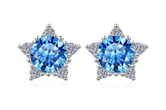 Star-shaped earrings with blue gemstones on a white background