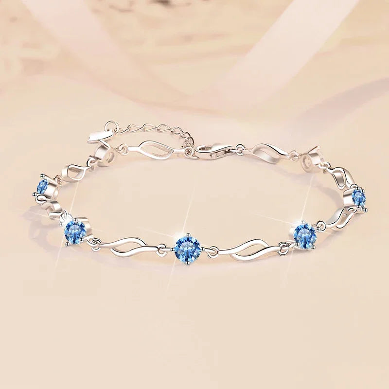 Silver bracelet with blue gemstones on a beige background