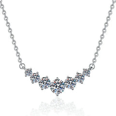 Silver necklace with diamond-like stones on a white background