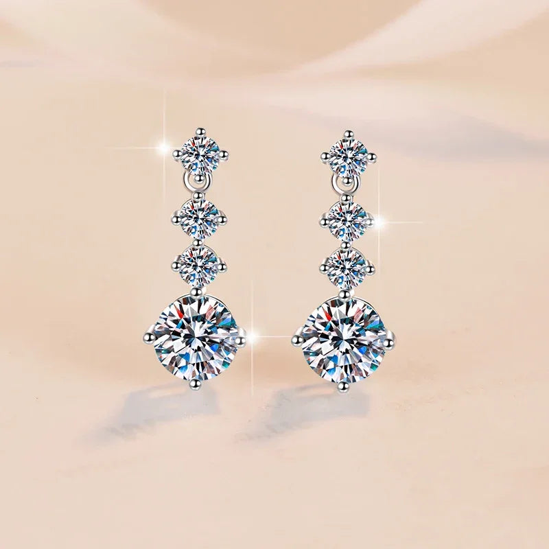Pair of diamond earrings on a beige background