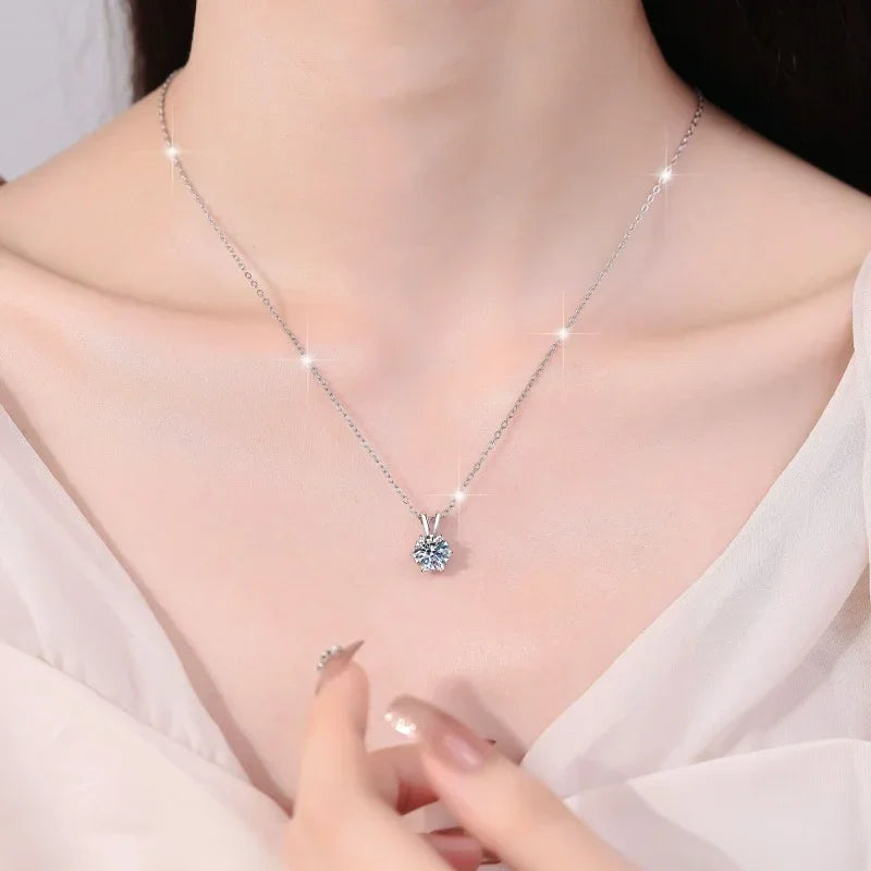 Close-up of woman wearing a platinum-plated silver necklace with a certified moissanite pendant