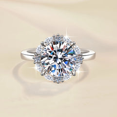 Silver ring with a large diamond on a beige background