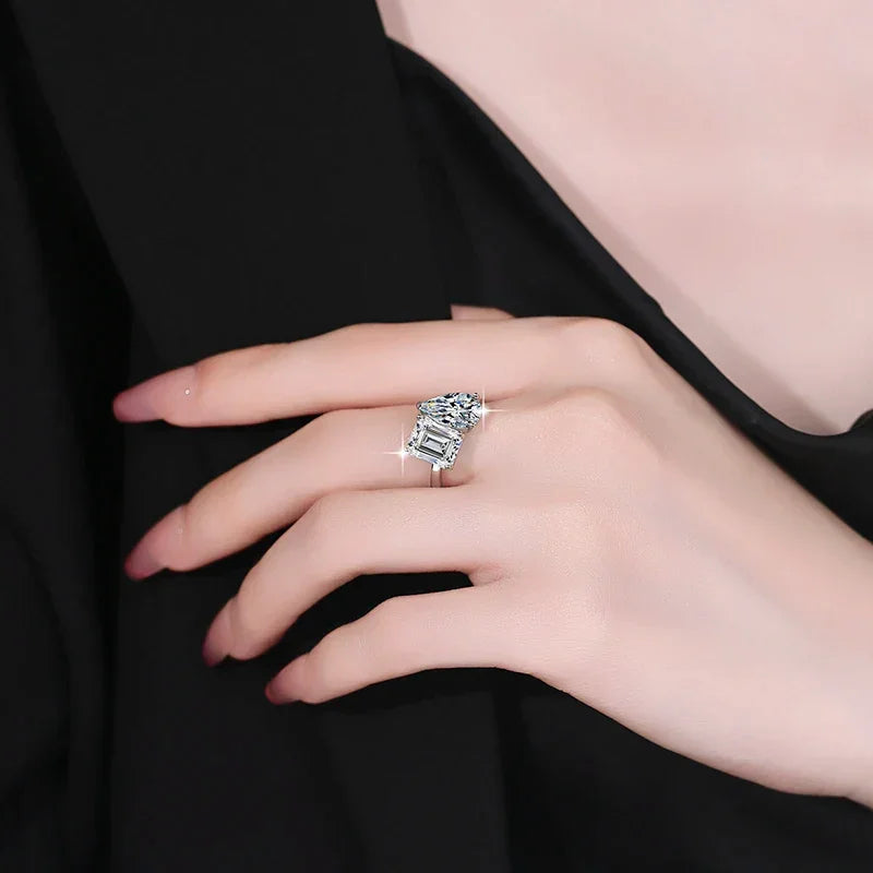 Silver ring on a hand against a black background