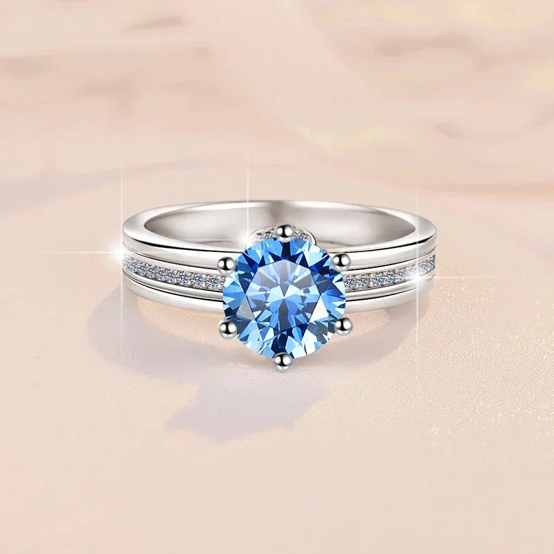 Silver ring with a blue gemstone on a beige background