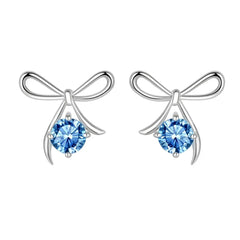 Bow-shaped earrings with blue gemstones on a white background