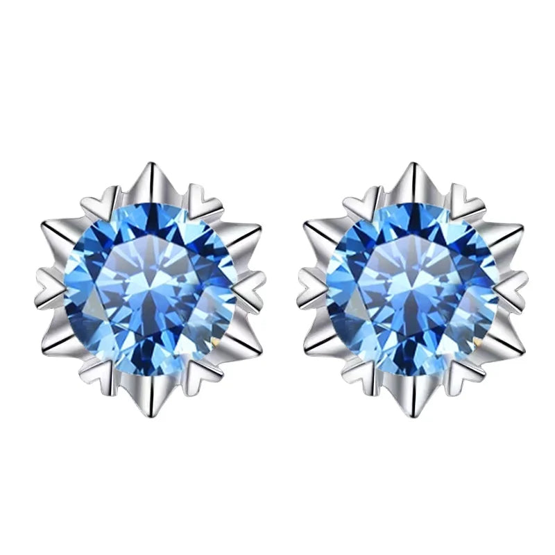 Pair of silver earrings with blue gemstones on a white background