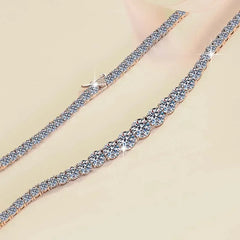 Rose gold bracelet with clear gemstones on a beige background