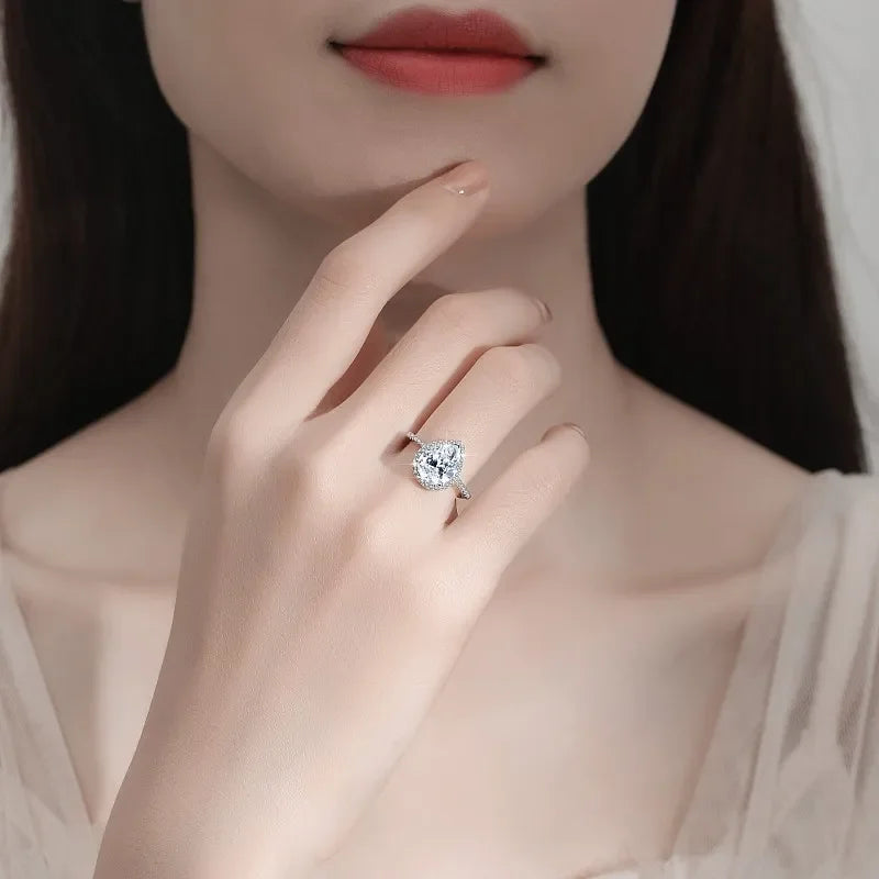 Close-up of a hand wearing a diamond ring with a blurred background