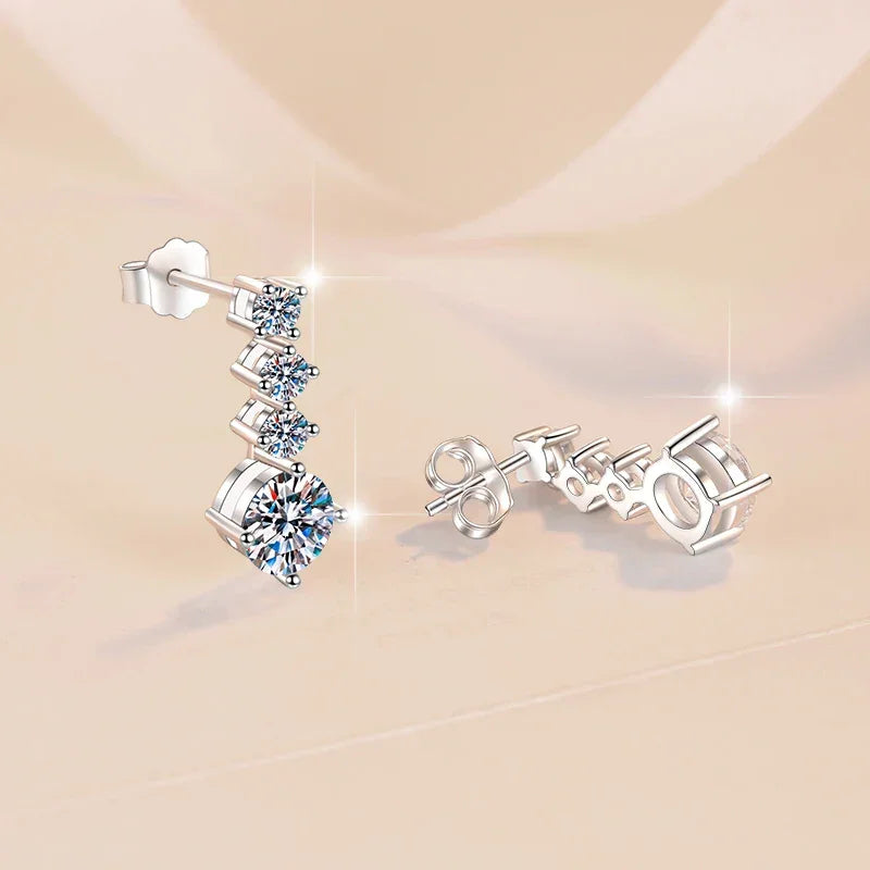 Silver earrings with gemstones on a beige background