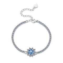 Silver bracelet with a blue gemstone on a white background