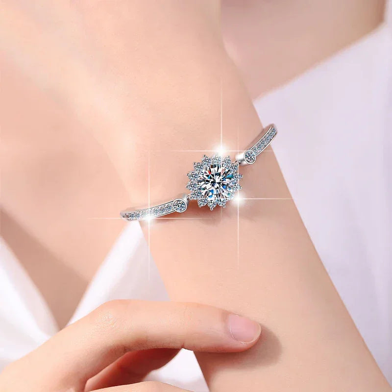 Silver ring with a large diamond on a person's finger against a white background