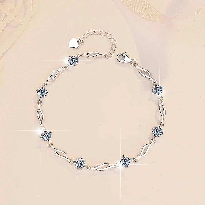 Silver bracelet with heart-shaped crystals on a beige background