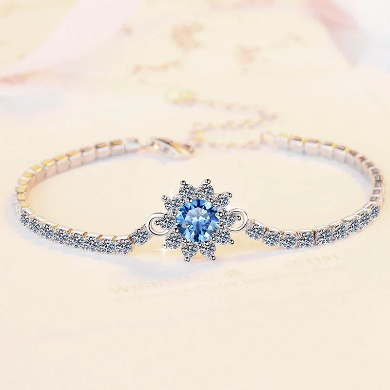 Delicate bracelet with a blue gemstone on a light background