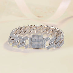 Silver chain bracelet with diamond accents on a beige background